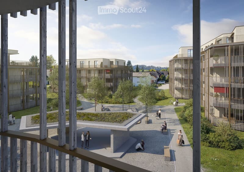 A modern residential complex with multiple buildings, green spaces, pathways, and people walking around.