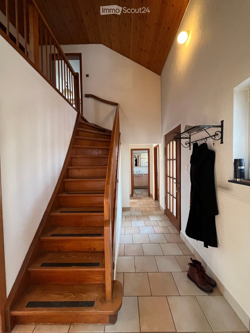 tiled floor, wooden stairs, coat rack, bathroom sink