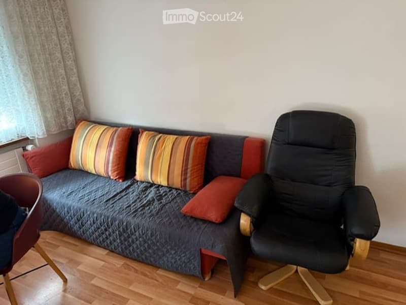 sofa, chair, and pillow, wooden floor, white curtain, white wall, desk