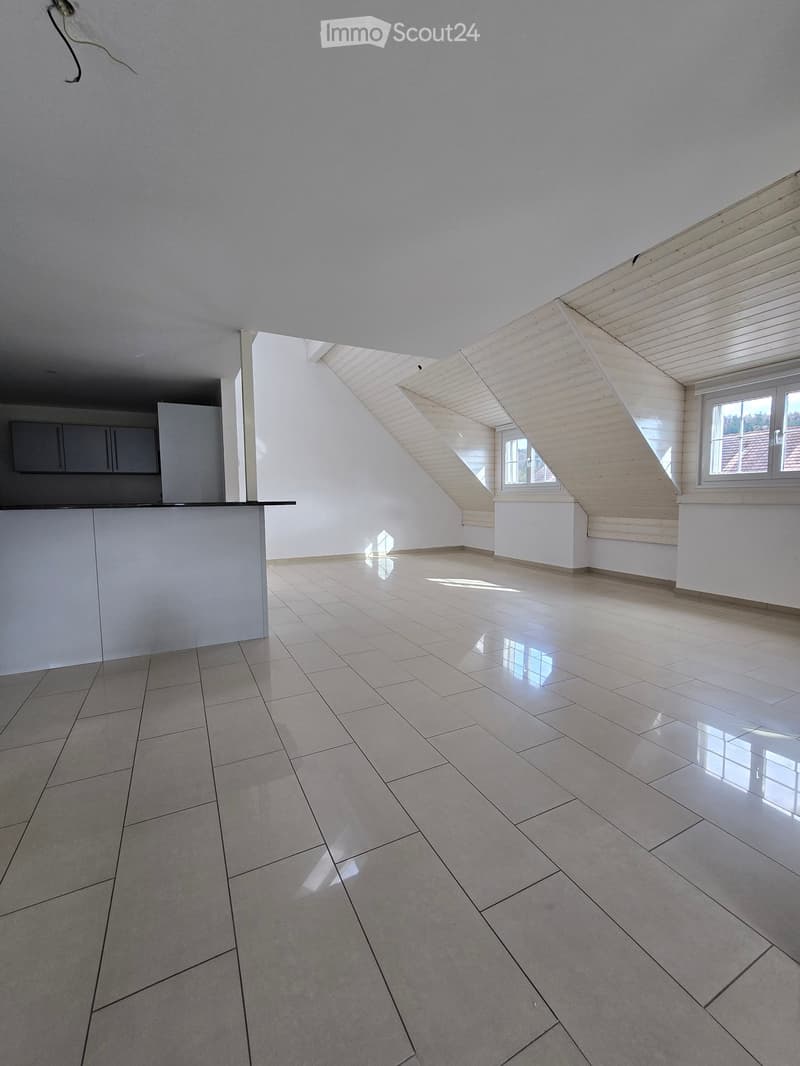 Empty room with white walls, tiled floor, and skylight windows allowing natural light. No furniture or equipment present.