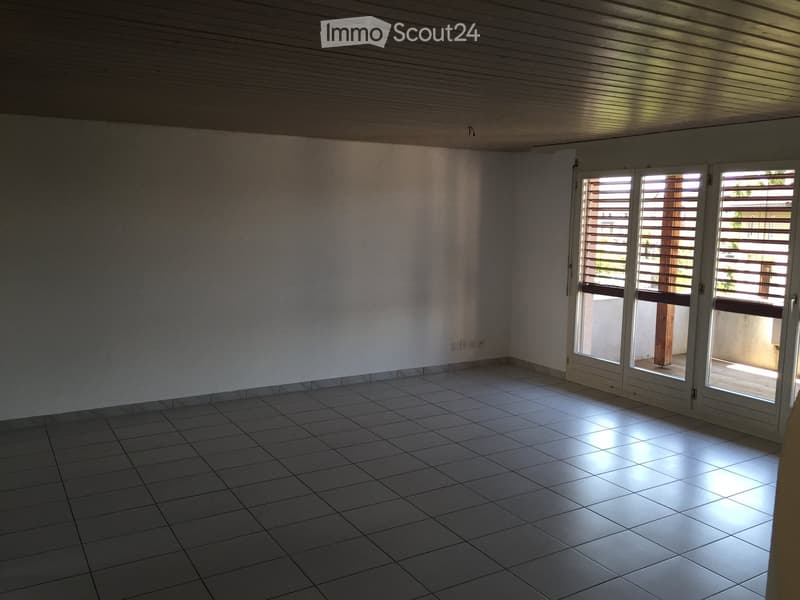 empty room, white walls, tiled floor, sliding glass doors to balcony