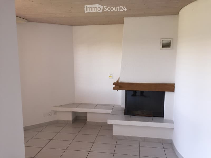 Corner room with fireplace, white walls, tiled floor, bench, power outlets