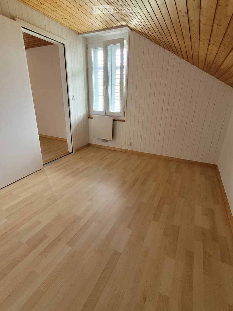 empty room, wooden ceiling, wooden floor, windows with shutters, heater