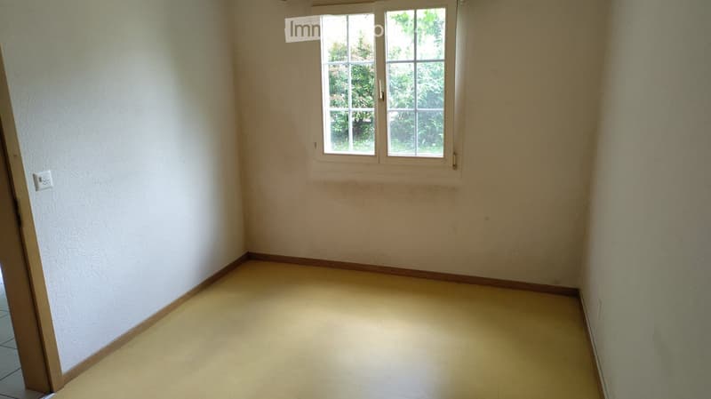Unfurnished Room. Empty room with light-colored walls, tiled floor, and a window with white frames. No furniture or equipment is present.