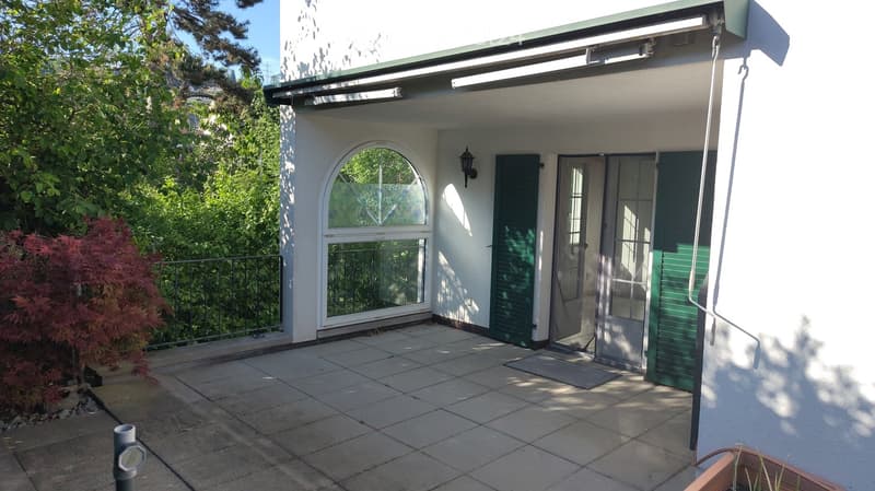 Balcony / Terrace. Balcony with tiled floor, white walls, green shutters, arched window, and metal railing.
