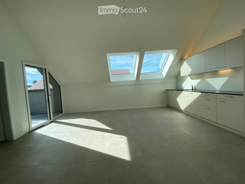 Empty room with tiled floor, white cabinets, and skylight windows allowing natural light to enter.