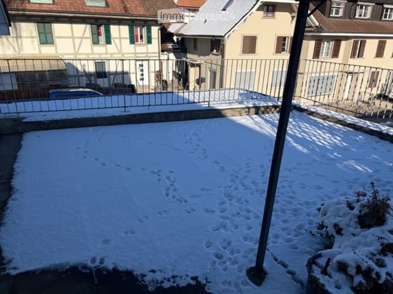 Snow-covered terrace, metal railing, footprint in the snow, fence with gate