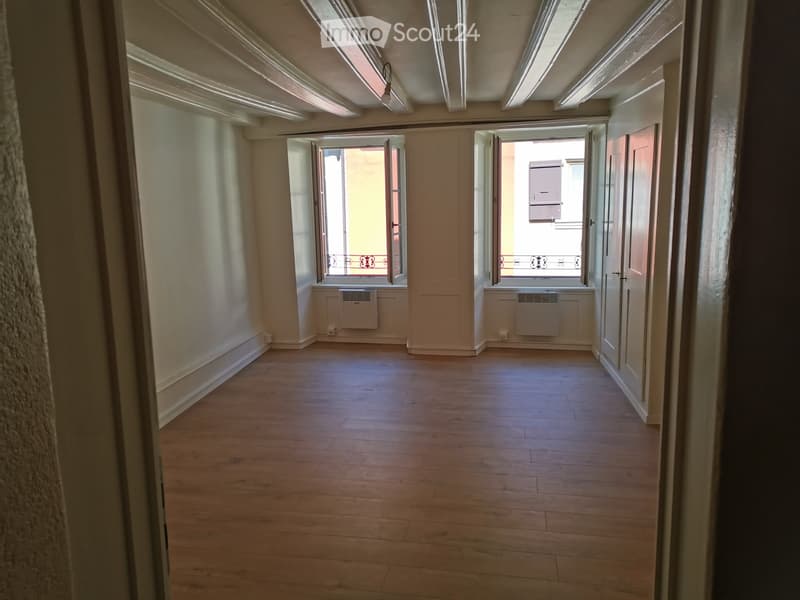 empty room, wooden floors, 2 large windows, balcony, no furniture
