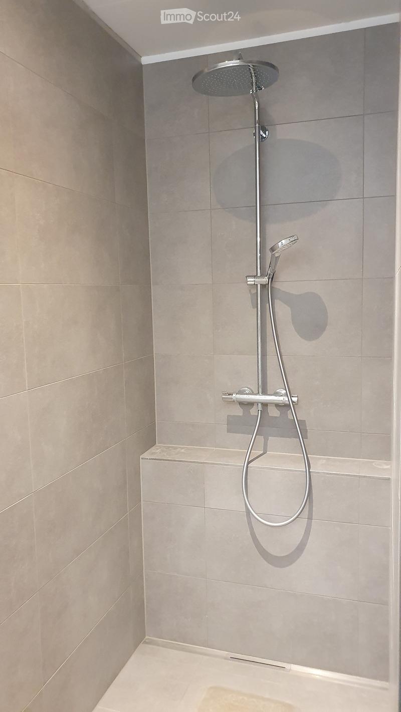 shower stall, tiled floor, shower head and hand shower