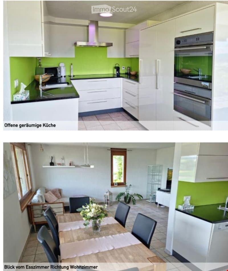 Modern kitchen with white cabinets, green accent wall, stainless steel appliances including oven, refrigerator, and dishwasher, and a central island with sink and faucet.