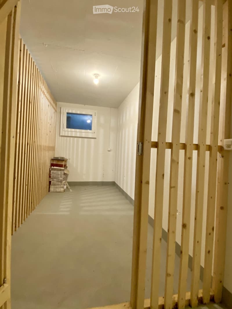 Empty room with unfinished walls, wooden framing, and a small window. No furniture or equipment present.