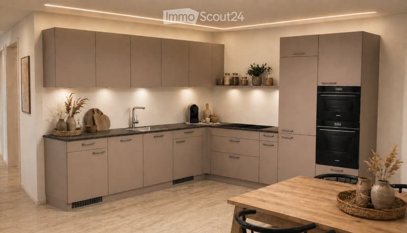 Modern kitchen with light grey cabinets, a central island, and a built-in oven. The space features a wooden dining table with chairs, decorative vases, and a small plant on the counter.