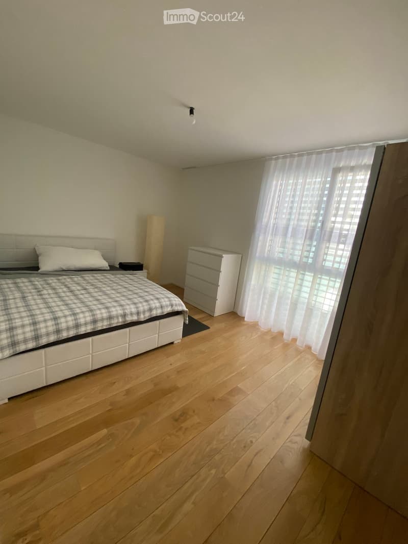 Other. {"visible_features": [],    "type": "Room",    "description": "Bedroom: bed with white leather headboard, plaid bedding, white pillow, night table with a lamp, white curtain, white drawer cabinet, wooden floor, ceiling lamp.",    "localized_desc