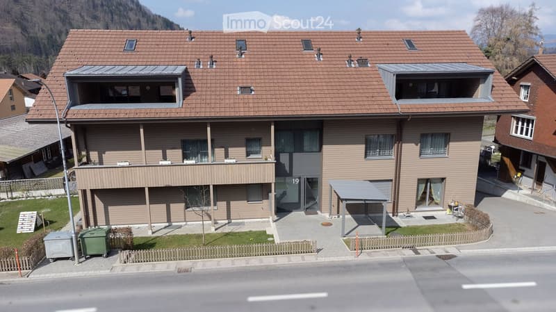 3 story house, brown roof, brown walls, balcony, carport, garden, street view