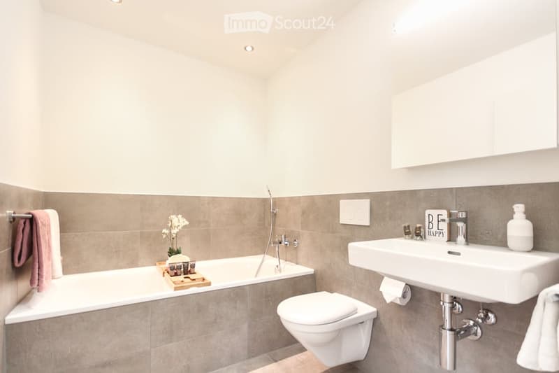 Bathroom with bathtub, toilet, sink, and shower