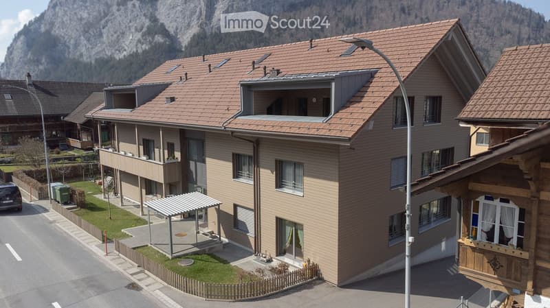 3 story house, brown roof, multiple balconies, windows, street view