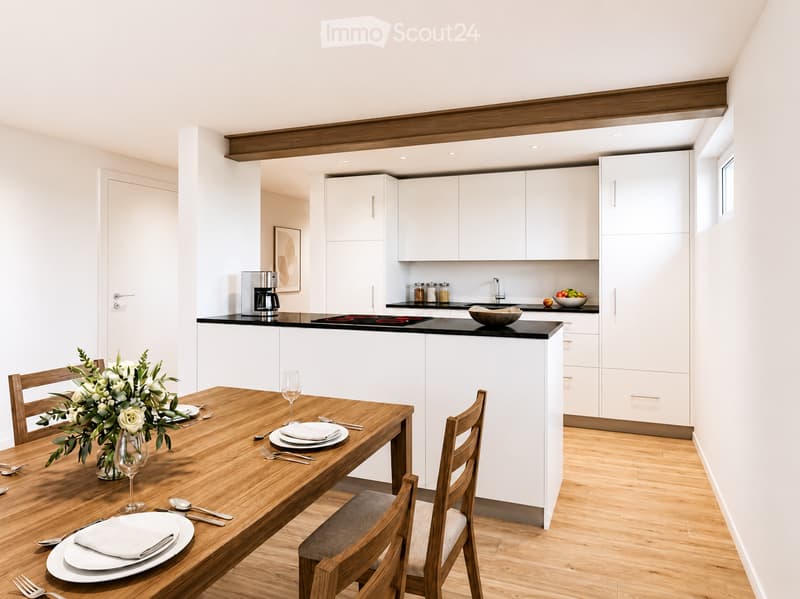Modern kitchen with white cabinets, wooden dining table, and chairs. Includes a coffee maker, sink, and decorative bowl on the counter.