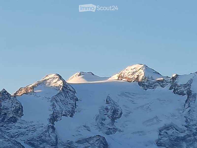 Snowy mountains with steep peaks, clear blue sky