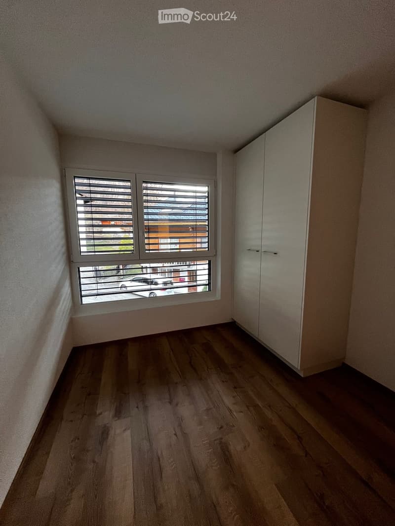 empty room, hardwood floors, large window, wardrobe