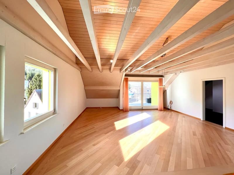 {"visible_features": ["View"],    "type": "Room",    "description": "Spacious attic room, wooden flooring, wooden ceiling beams, large window with curtain, door leading to balcony with railing",    "localized_descriptions":        {        "EN": "Spa