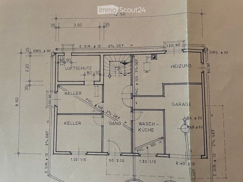 Floor plan of a basement level showing a cellar, airlock, heating room, garage, and wash-kitchen area.