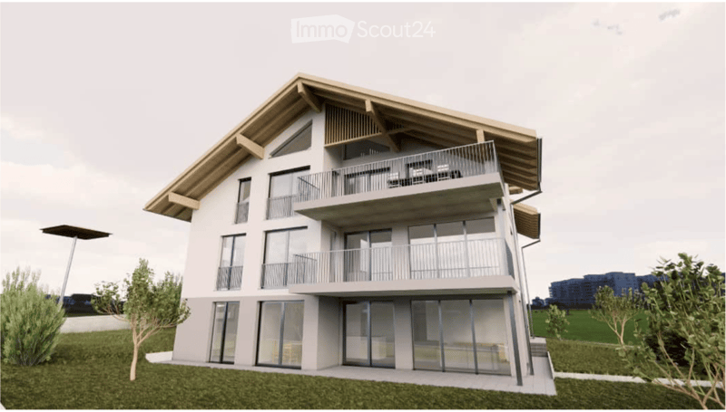 Modern three-story building with balconies, large windows, and a sloped roof.