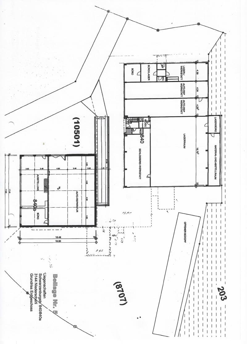 Floor plan of a commercial building showing multiple rooms including a workshop, office, storage, and parking area.