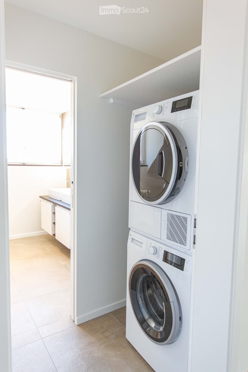 {"visible_features": ["Private washing machine"], "type": "Laundry room", "description": "Stacked washing machine and dryer in a small room, tile flooring, open doorway leading to another room with sink", "localized_descriptions": {"EN": "Laundry room: st