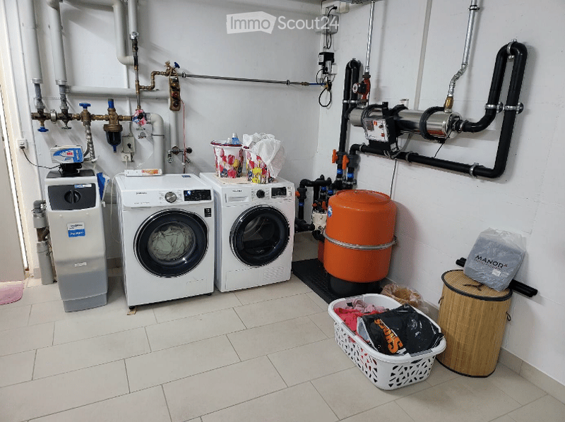 Two washing machines, one dryer, water softener, water tank, laundry basket, trash bin