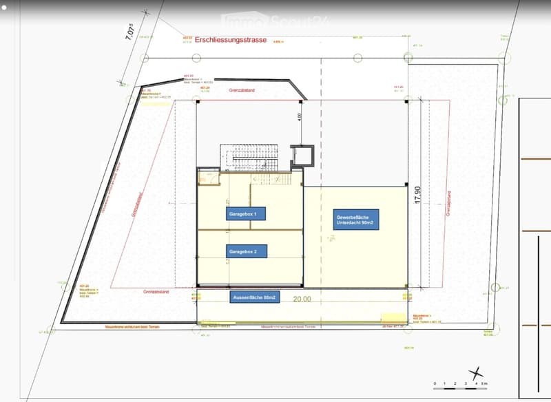 Floor plan showing a property layout with two garage boxes, an outdoor area, and a commercial space underground.
