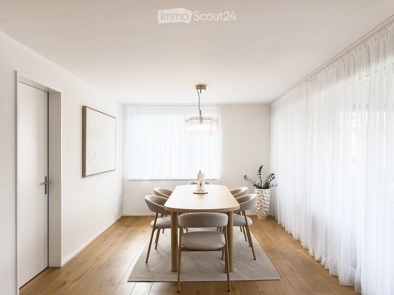 Modern dining room with a wooden dining table, six chairs, a chandelier, a potted plant, and a picture frame on the wall.