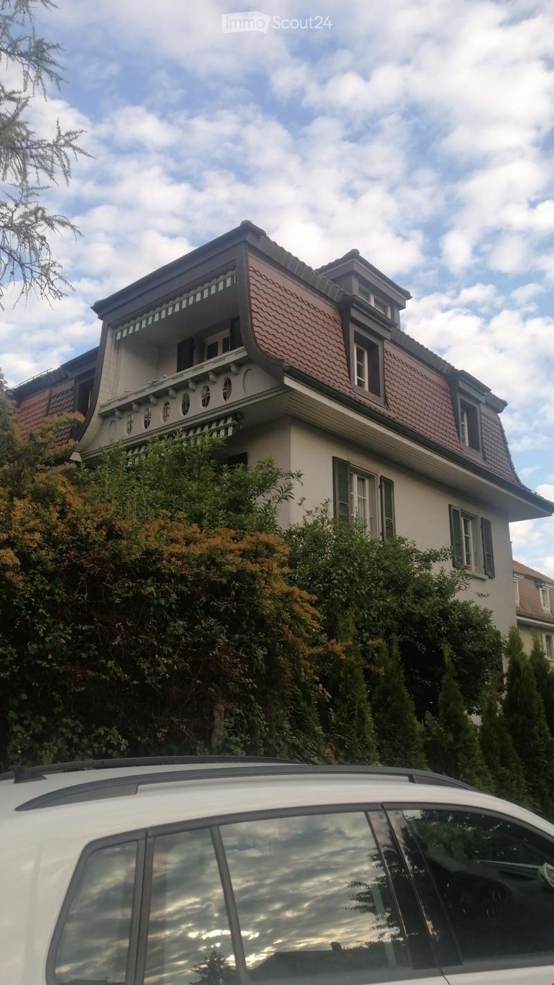 3 story house, brown roof, balcony, large windows