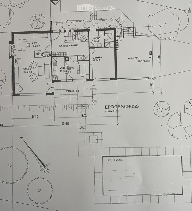 Floor plan of a house showing a living room, dining area, kitchen, bedroom, bathroom, entrance hall, and garage entrance.