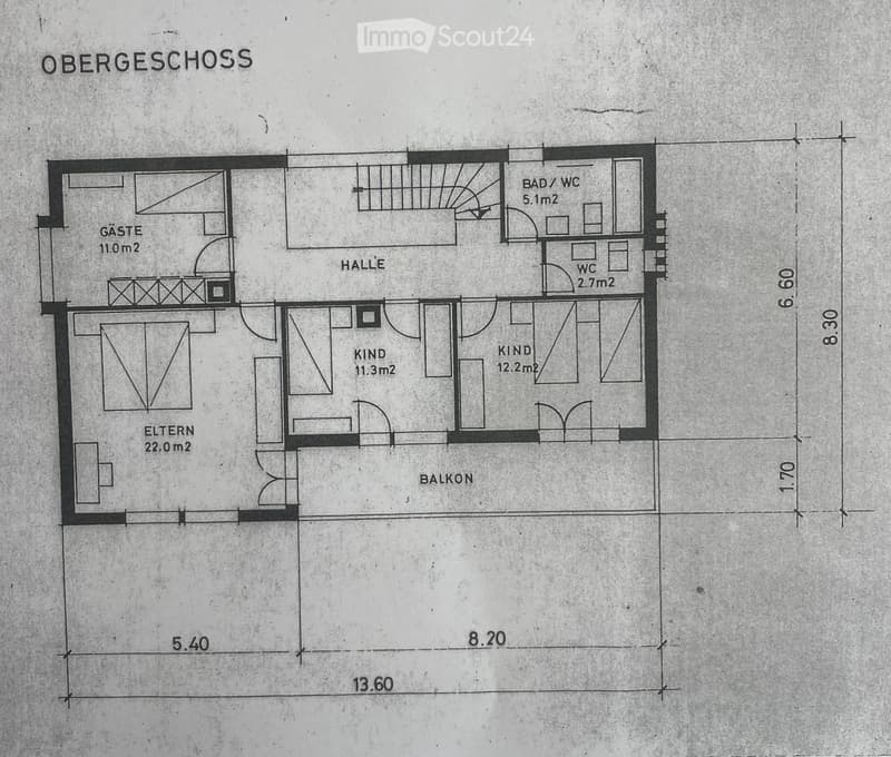 Floor plan of the upper level showing a hallway, two bedrooms, a bathroom, a guest room, and a balcony.
