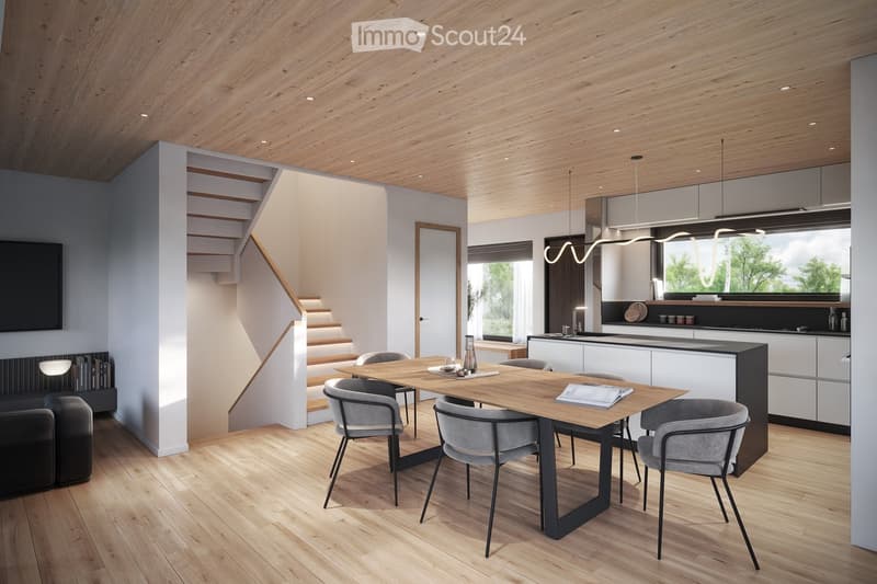 The image shows an open concept living room and kitchen area with a wooden ceiling, hardwood floors, and a modern, minimalist design. The kitchen features sleek, dark cabinets and a large wooden dining table with grey chairs. There is a fireplace visible