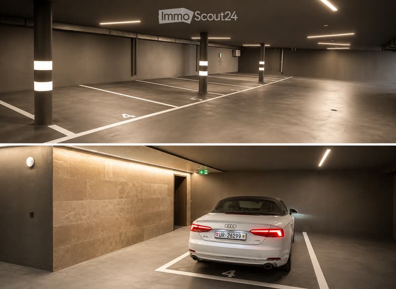 Modern underground parking area with concrete floors and walls, marked parking spaces, and a white Audi convertible parked in one of the spots.