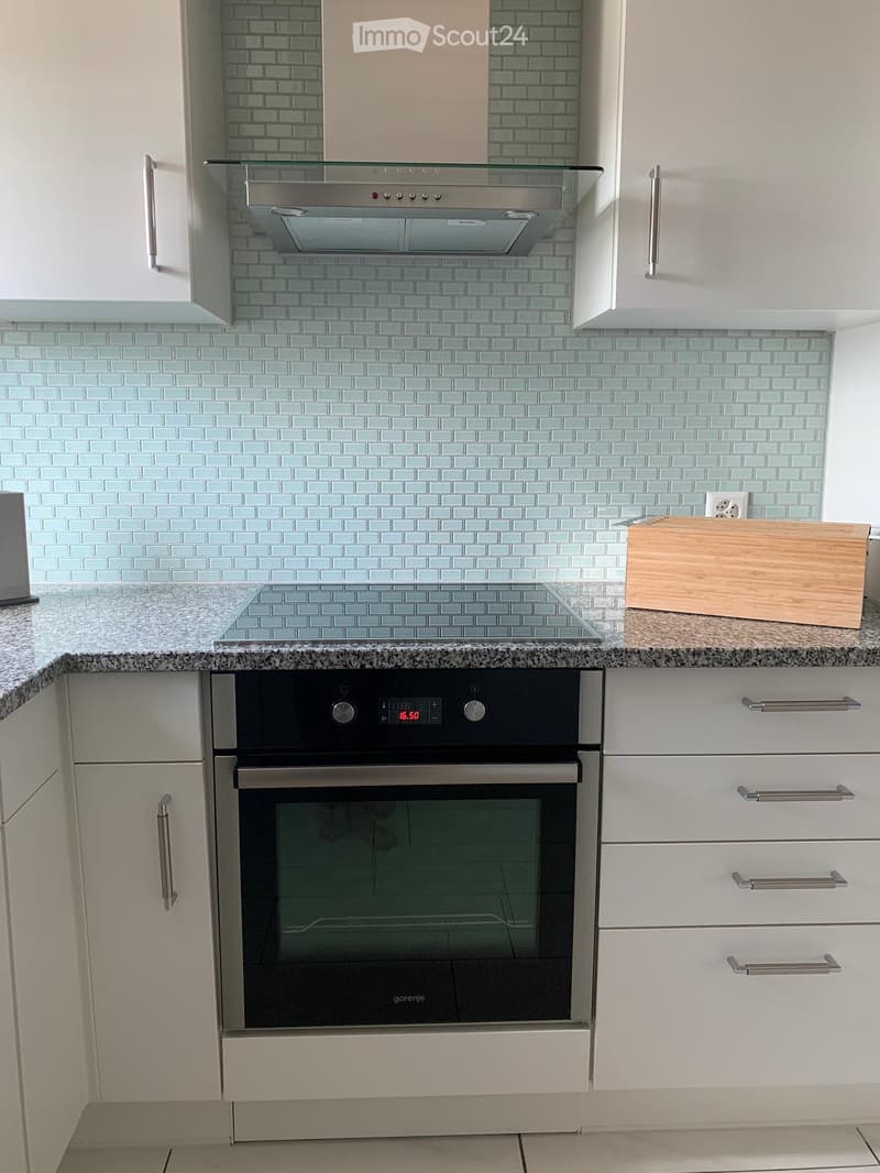 modern kitchen, built-in oven, induction hob, under-counter drawers, open shelves, tiled backsplash, white cabinets