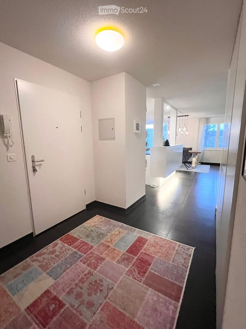 Modern hallway with dark flooring, light and spacious, carpet, open plan