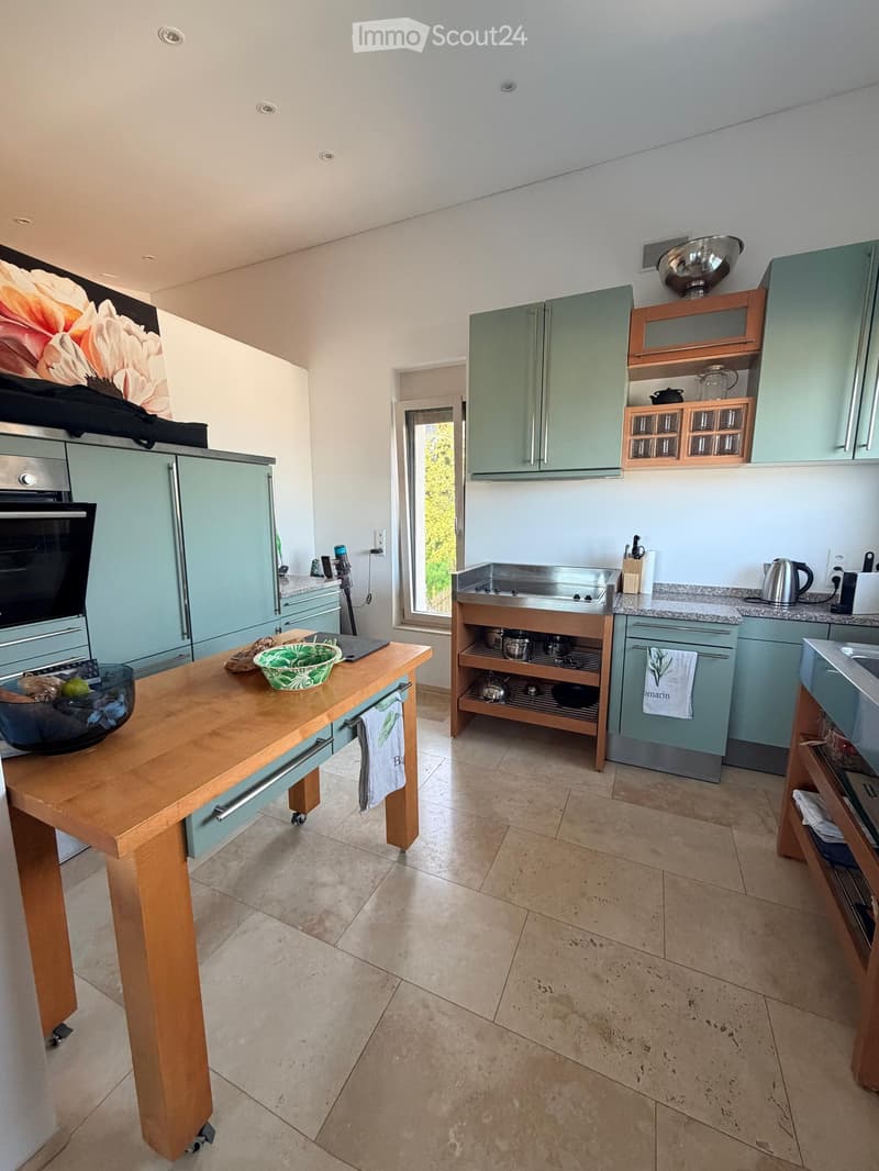 {"type": "Kitchen", "objects": ["refrigerator", "oven", "sink", "kitchen island", "cupboard", "table", "bowl", "towel", "cupboard", "faucet", "cupboard", "cupboard", "cupboard", "cupboard", "cupboard", "cupboard", "cupboard", "cupboard", "cupboard", "cupb