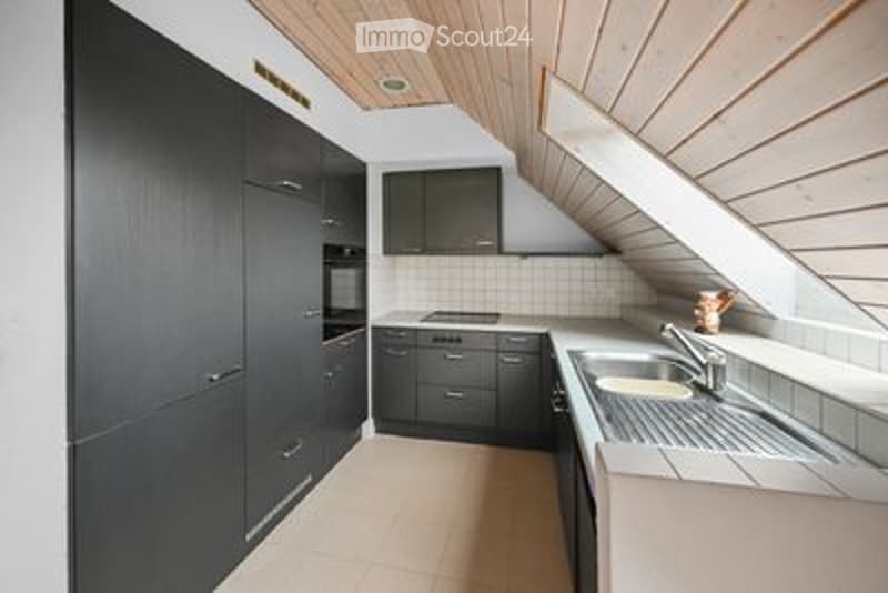 Modern kitchen with black cabinetry, stainless steel appliances, and a sleek design. Features a stove, sink, and ample storage space.
