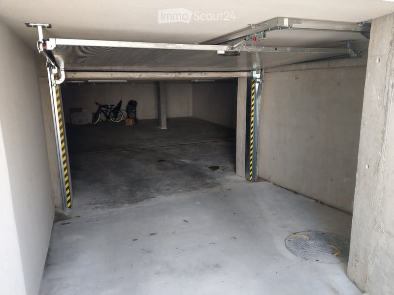 {"type": "Garage", "objects": ["bicycle"], "description": "Underground garage with concrete floors and walls, a single bicycle, and a partially open automatic door.", "localized_descriptions": {"EN": "Underground garage with concrete floors and walls, a s