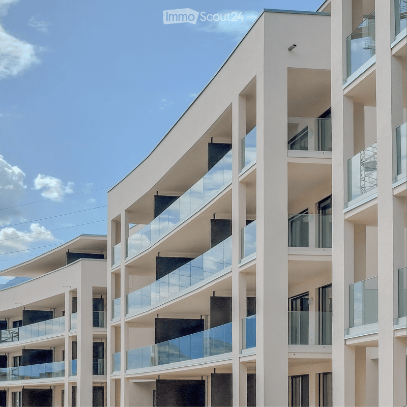 modern apartment building, multiple floors, glass balconies