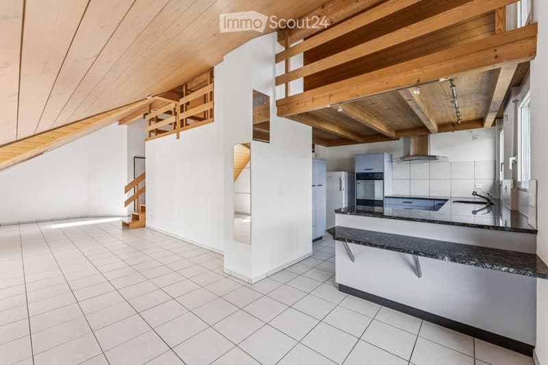 Open-plan kitchen and living area with white tiled flooring, light wooden beams, and modern appliances including a refrigerator, oven, and sink.