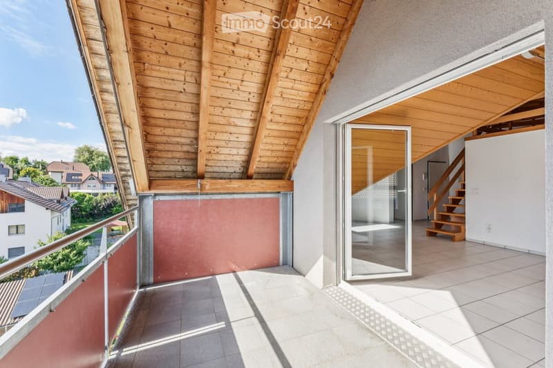 Balcony with wooden ceiling, tiled floor, metal railing, and a view of the neighborhood.