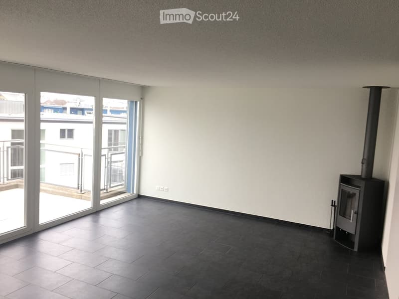 empty room with tiled floor, fireplace, sliding glass doors leading to a balcony