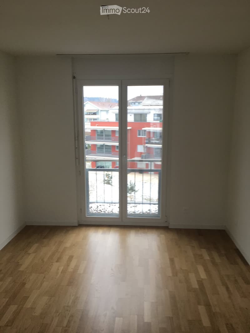 empty room, wooden floor, white walls, large glass door with balcony