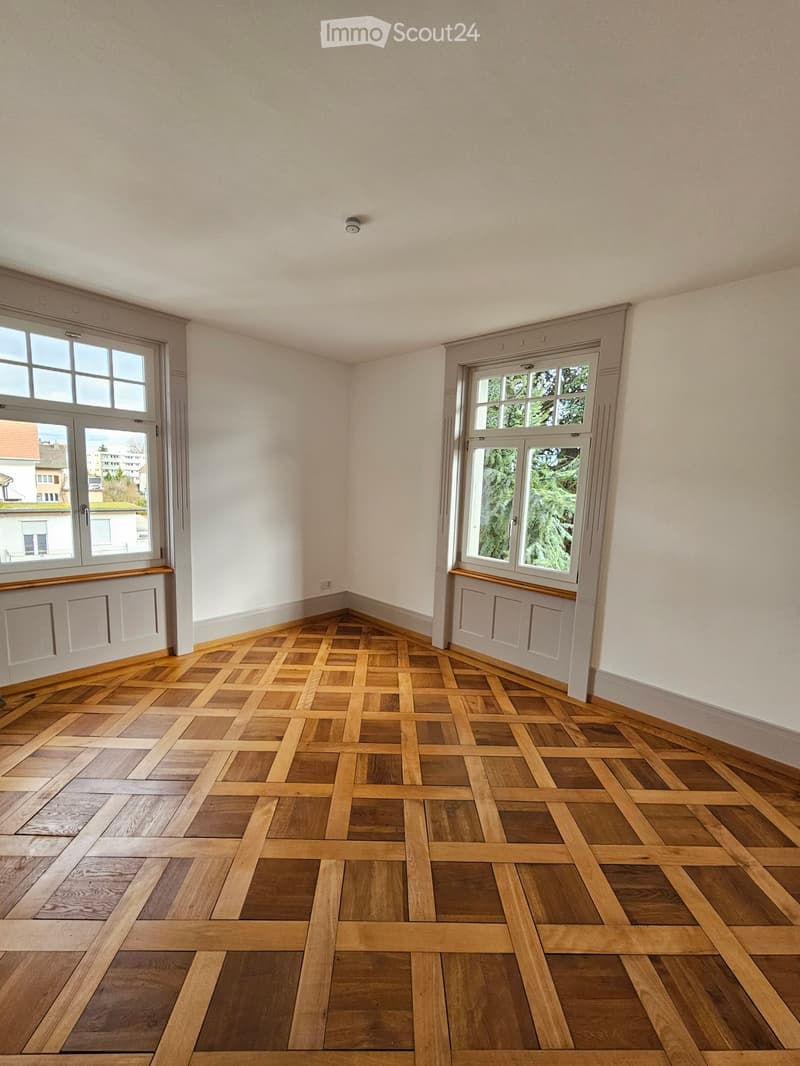 empty room, wooden parquet flooring, white walls, two windows, modern design