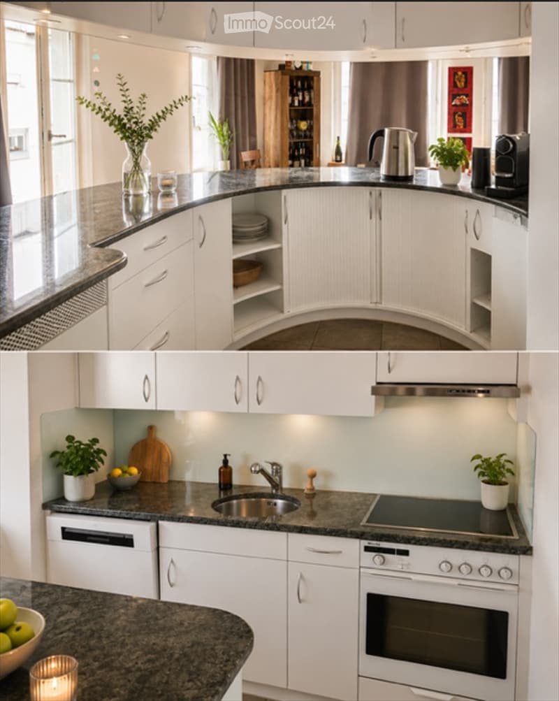 Modern kitchen with white cabinets, granite countertops, stainless steel appliances including a sink, oven, stove, and dishwasher. Decor includes plants, a vase, a candle, and a cutting board.