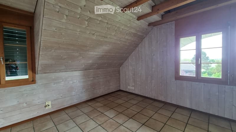 empty room, wooden walls, tiled floor, two windows, power outlets