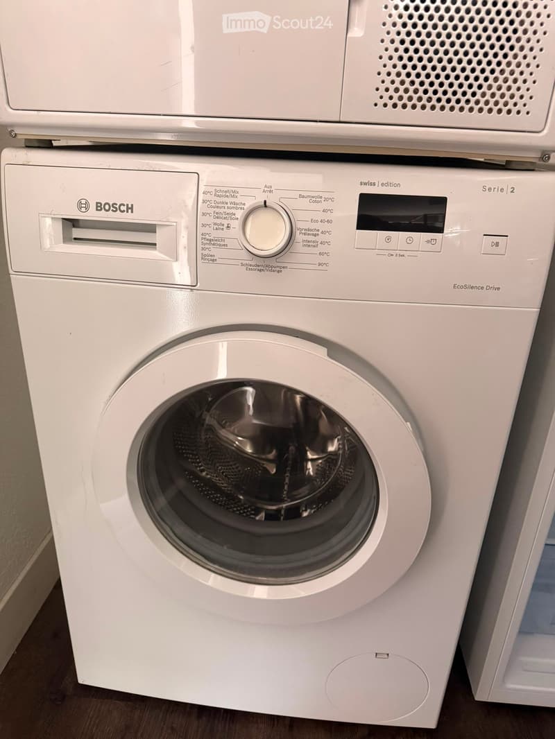 White Bosch washing machine and dishwasher stacked vertically, with control panels and various washing cycles displayed.